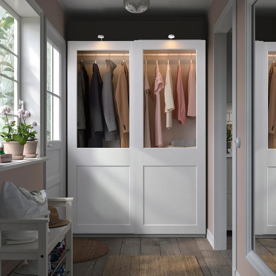 PAX wardrobe: floor-to-ceiling, white, glass-topped, fits neatly, displays clothes.