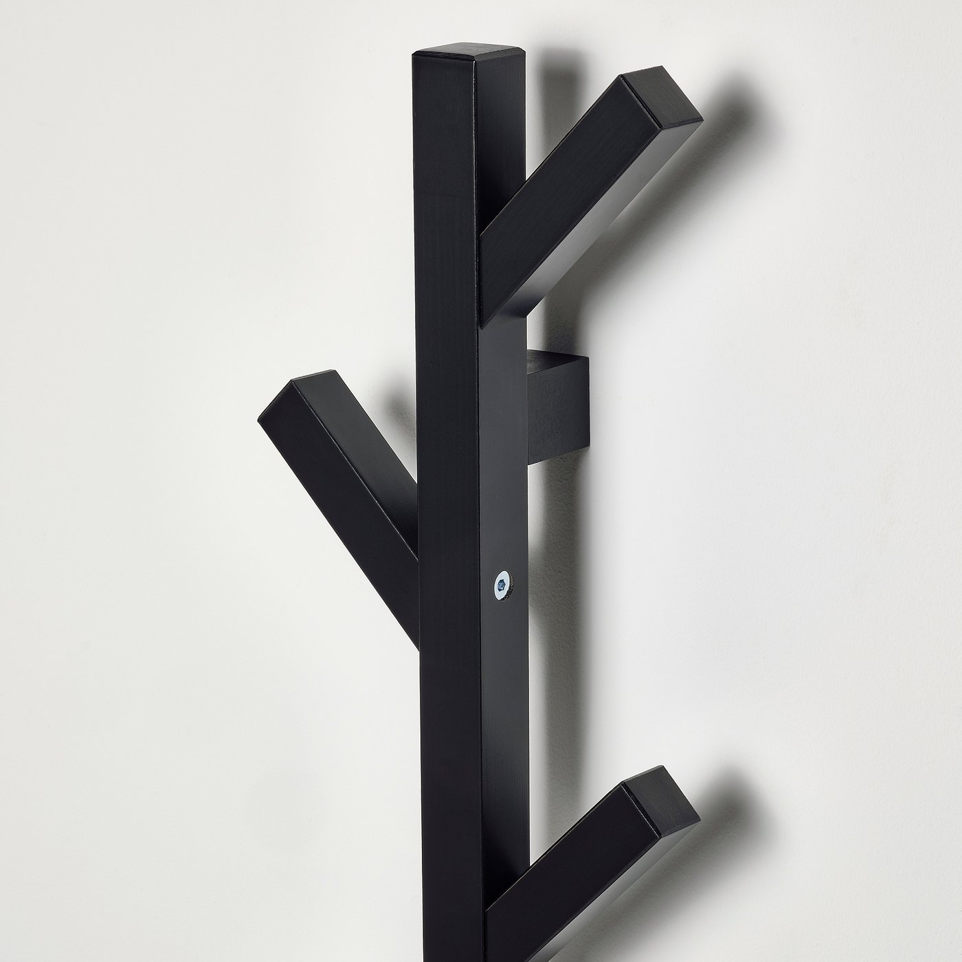 Black wooden coat rack with multiple hooks, designed for organising jackets and accessories.