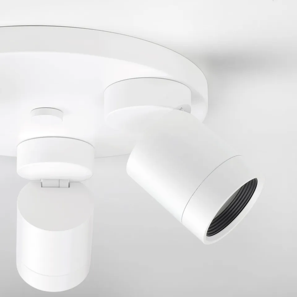 Modern white ceiling lamp with adjustable spotlights; clean, sleek design.