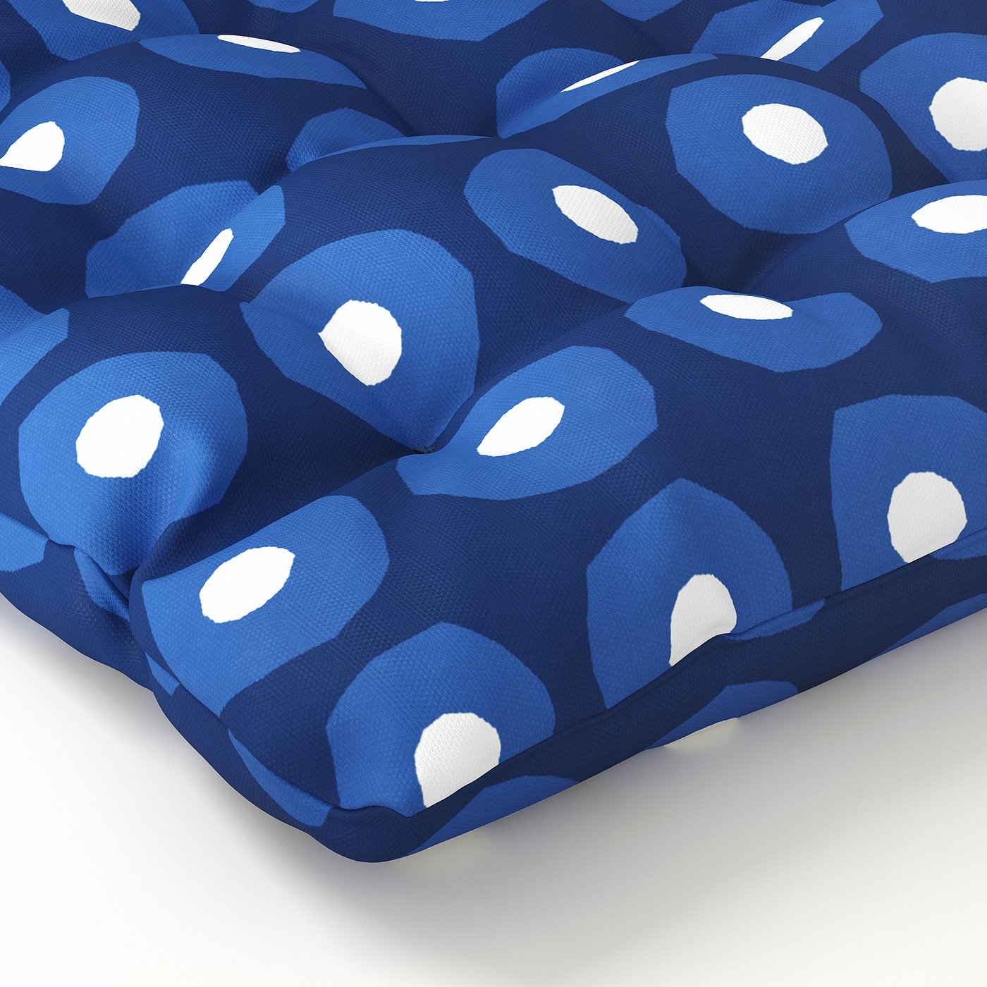 Blue patterned cushion with white spots, fabric looks soft and durable.
