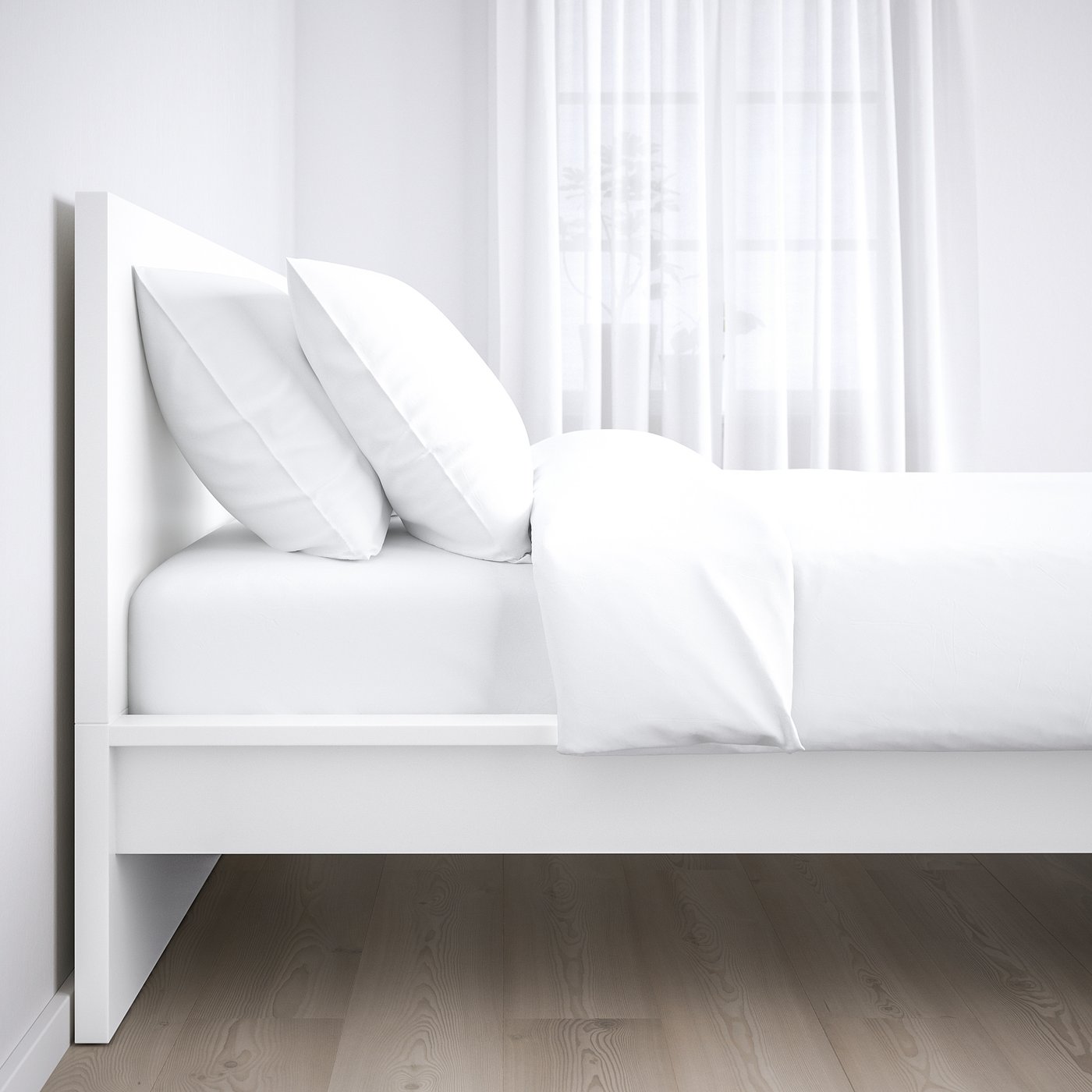 White modern bed with crisp linens and wooden floor, setup against a light curtain.