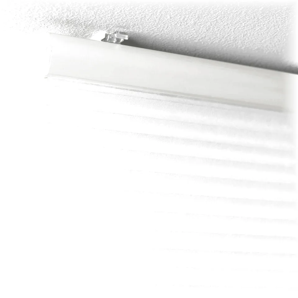 Closed white HOPPVALS cellular blind filtering daylight, mounted on ceiling. Honeycomb design insulates air, offering privacy and light dimming.