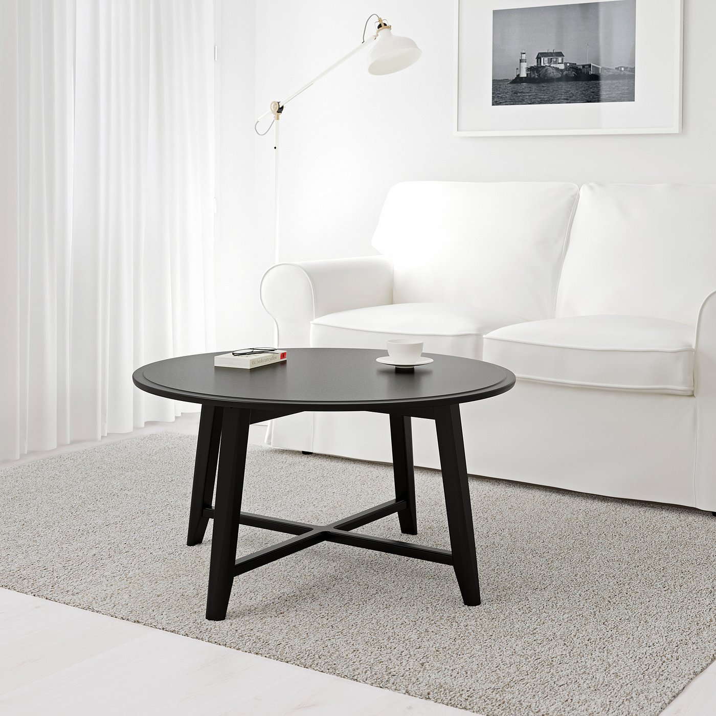 Modern living room with KRAGSTA table and white armchair.