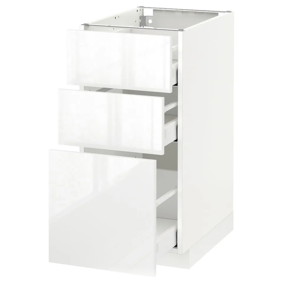 A white, modern kitchen cabinet from the METOD system, featuring three high-gloss, smooth-running drawers.