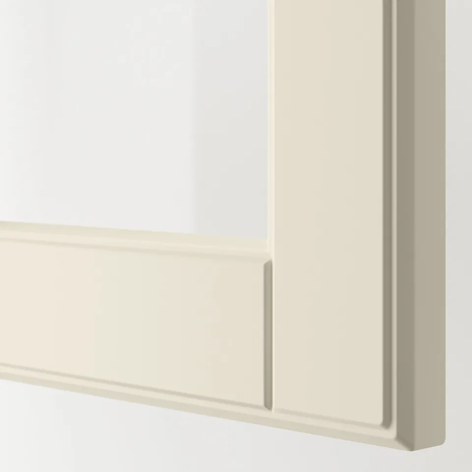 Close-up of smooth, off-white cabinet door with bevelled glass edges, part of METOD kitchen system.
