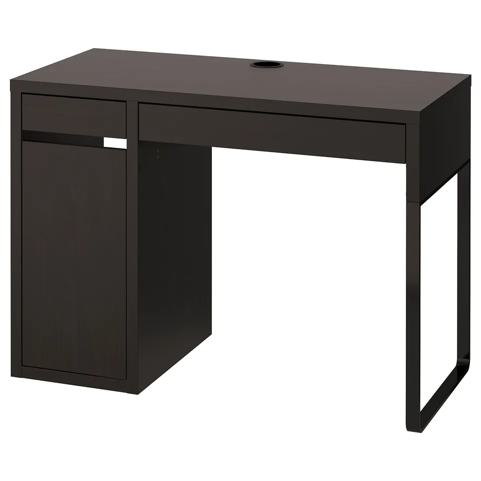 A black MICKE desk. Its rectangular with one drawer and a cabinet for storage. The design is modern and minimalist, perfect for small spaces.