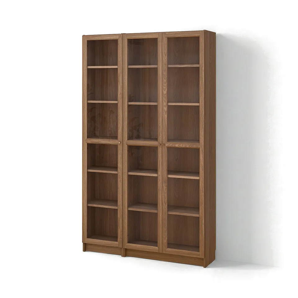A BILLY bookcase with glass doors. Its brown, rectangular, and multiple shelves for storage.
