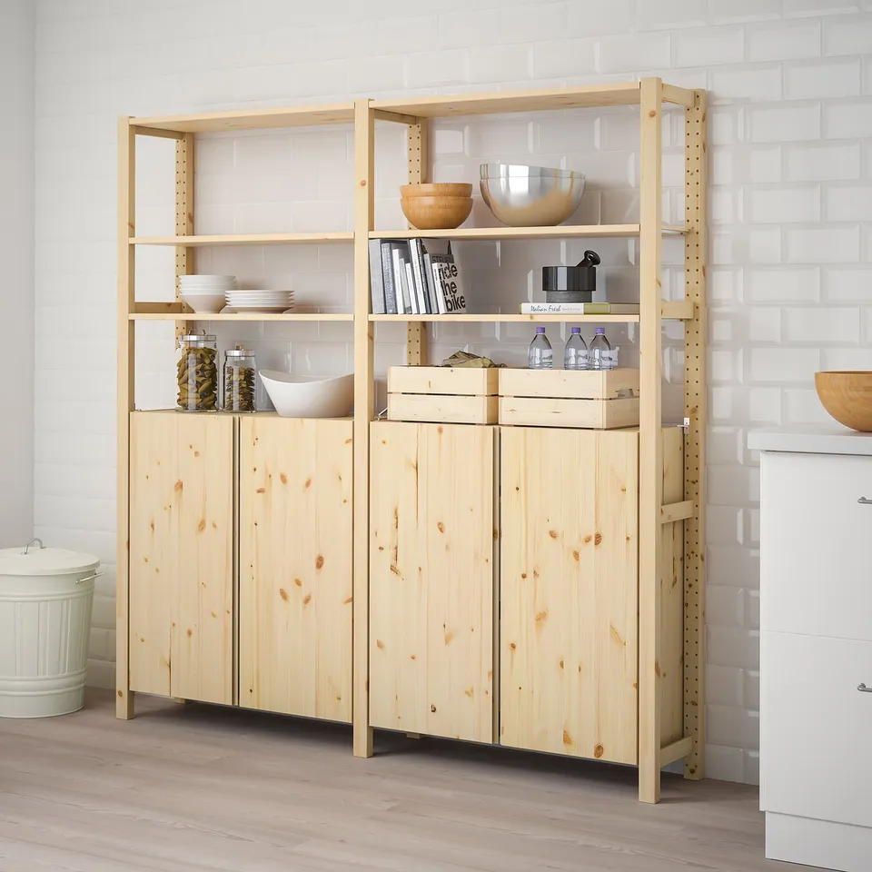 IVAR shelves & cabinet, beige, rectangular, multi-shelf with bowls, jars, & books against a white wall.