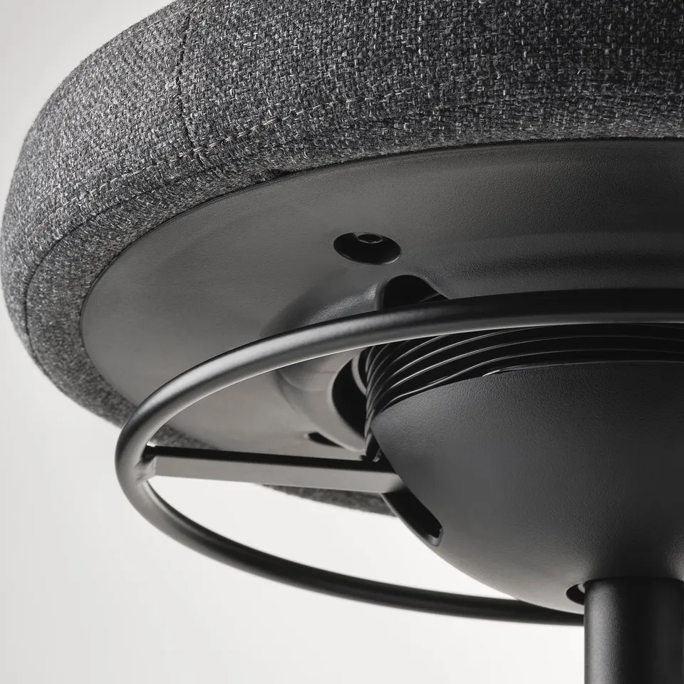 Close-up of a modern office chairs mechanism, showing sturdy metal construction and smooth finish.