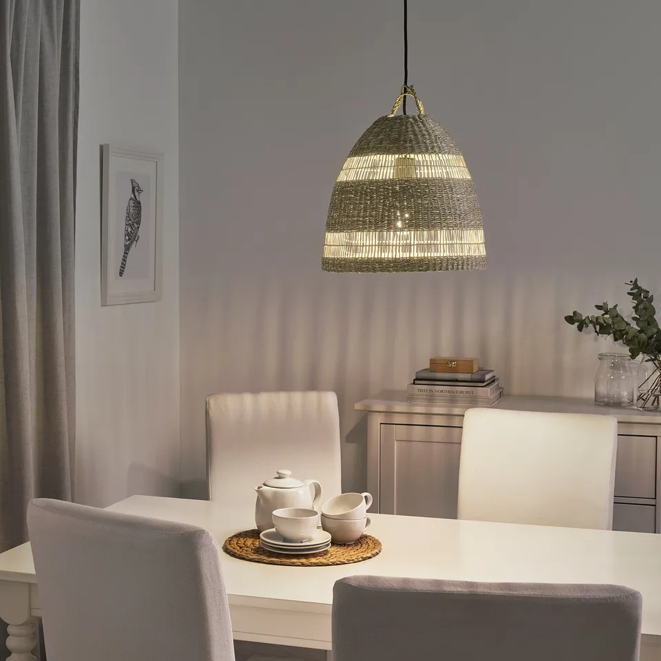 Modern dining room with TORARED pendant light, soft lighting, white table, grey chairs, and minimalist decor.