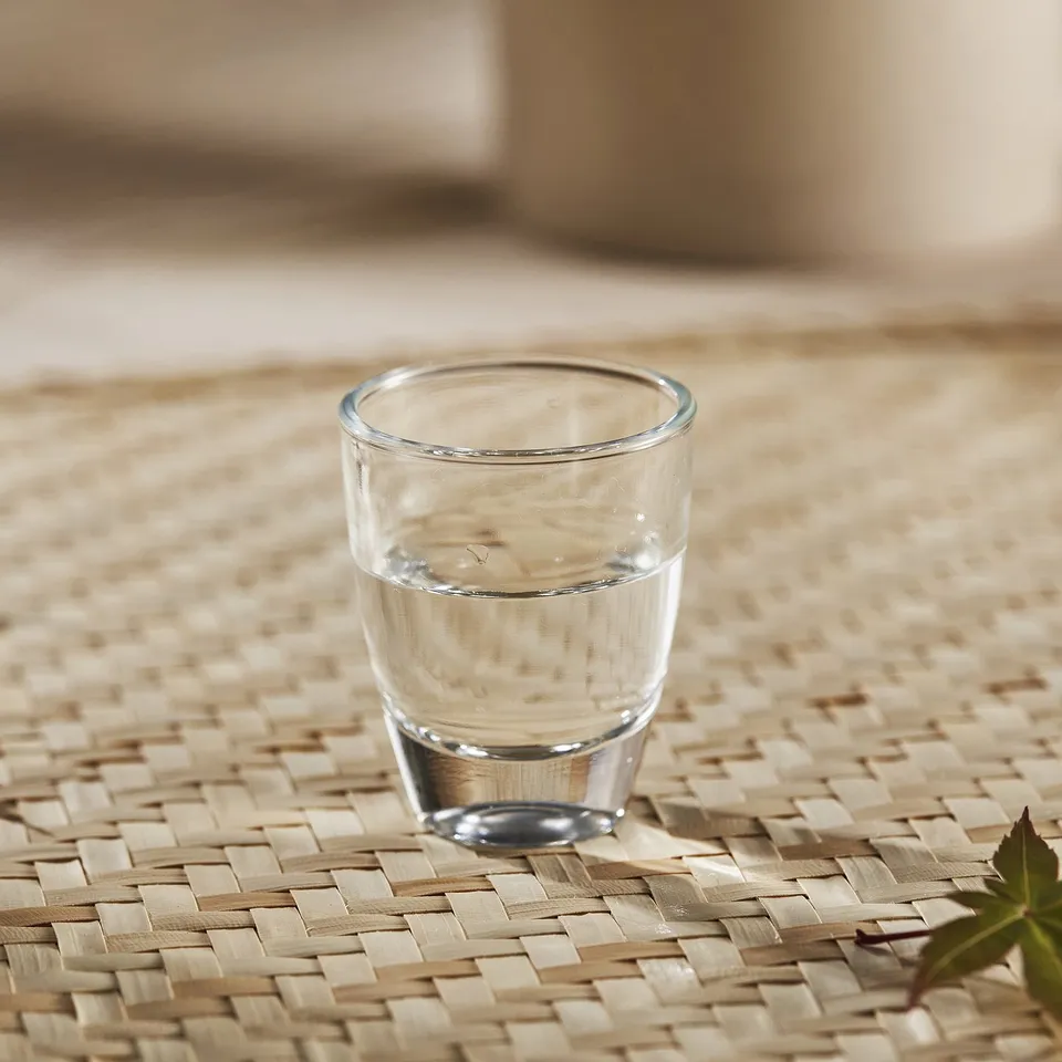 Small glass on mat, perfect for strong drinks.