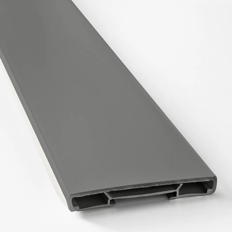 Grey plastic plinth for kitchen cabinets, smooth and sleek with matching colour underside, shown at an angle.