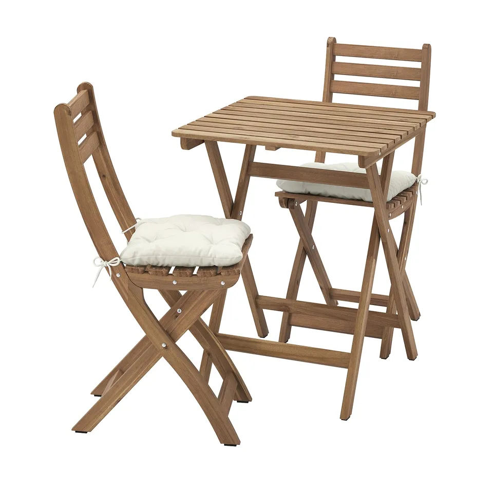 Wooden outdoor table and two chairs with beige cushions, folded for storage.