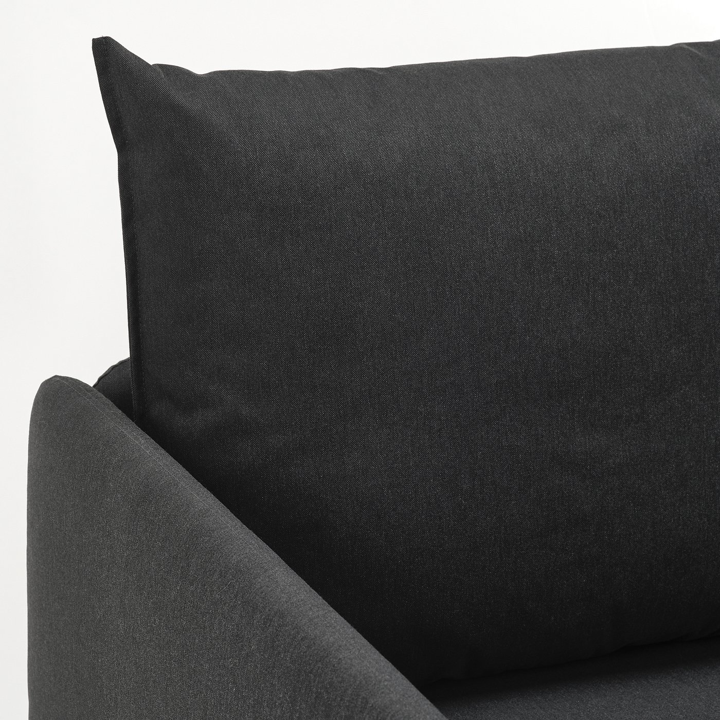 Black sofa cushion close-up, plush and textured, showcasing high-quality upholstery.