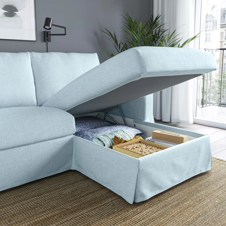 Light blue sofa with storage chaise, lid stays open for easy access.