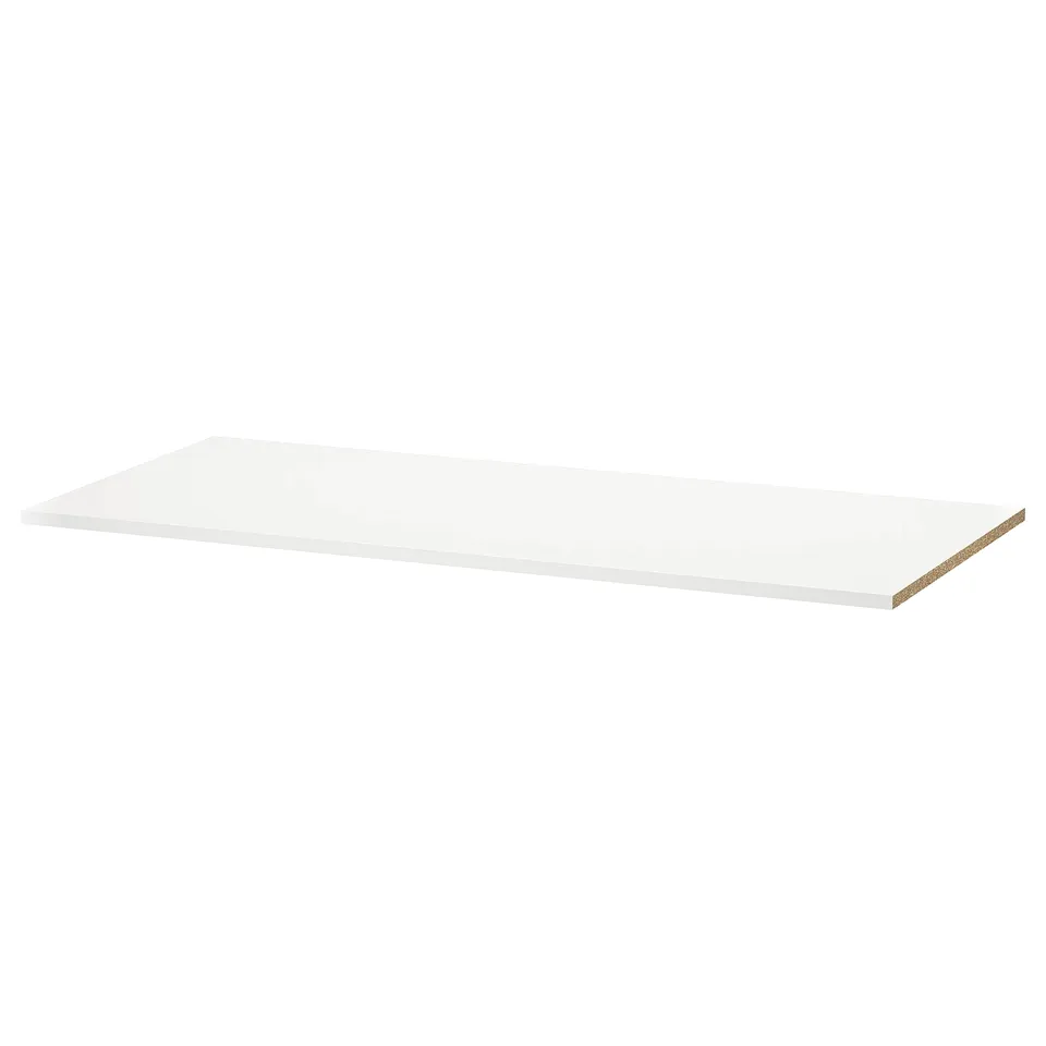 A white UTRUSTA shelf. It's rectangular, made of melamine, and designed for corner cabinets.