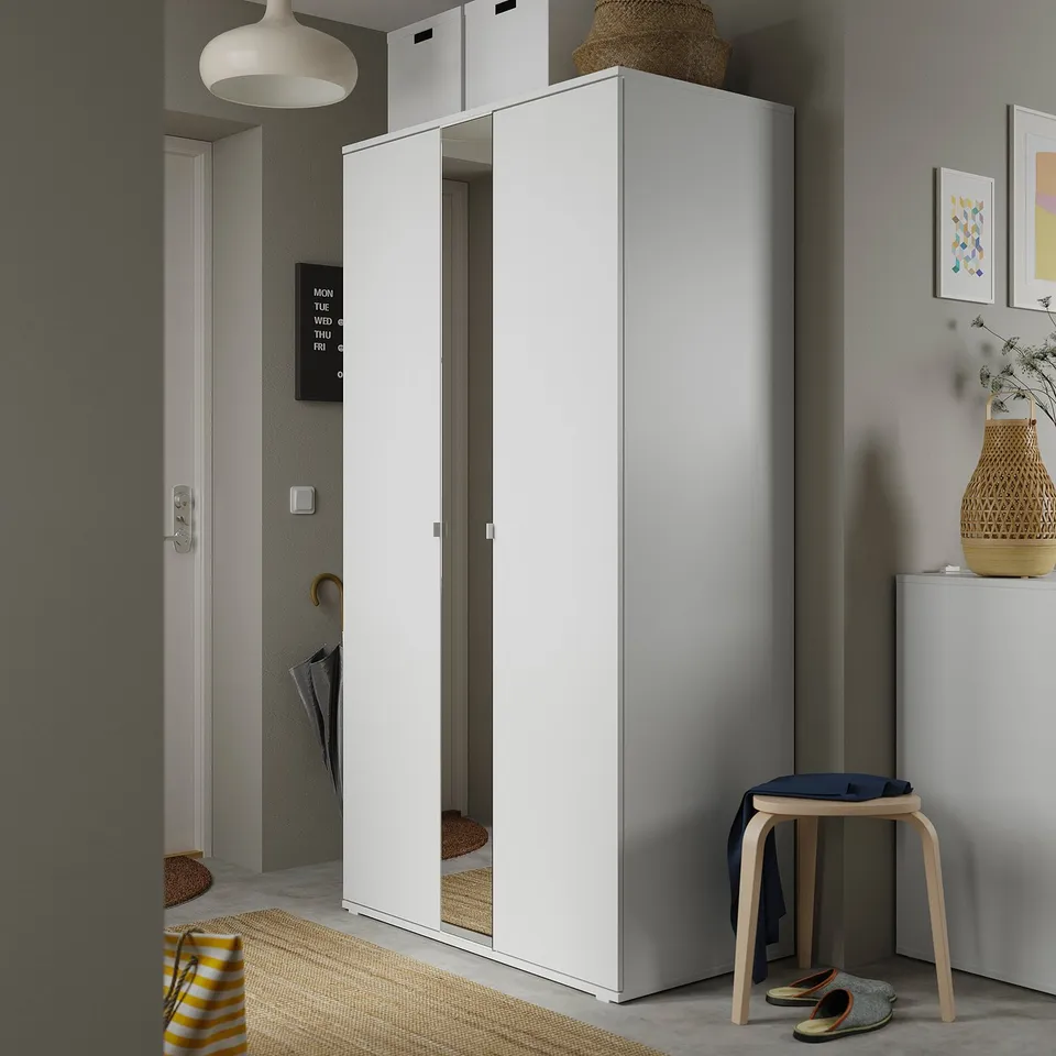 Modern hall with white VIHALS wardrobe, mirror doors, wooden stool, wicker vase, and grey walls.