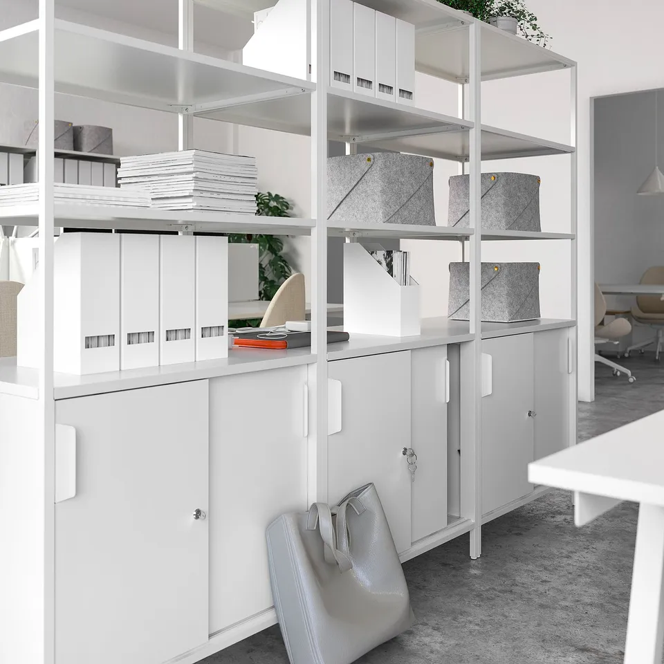 Modern white office cabinet with open shelves and lockable drawers, dividing workspace neatly.