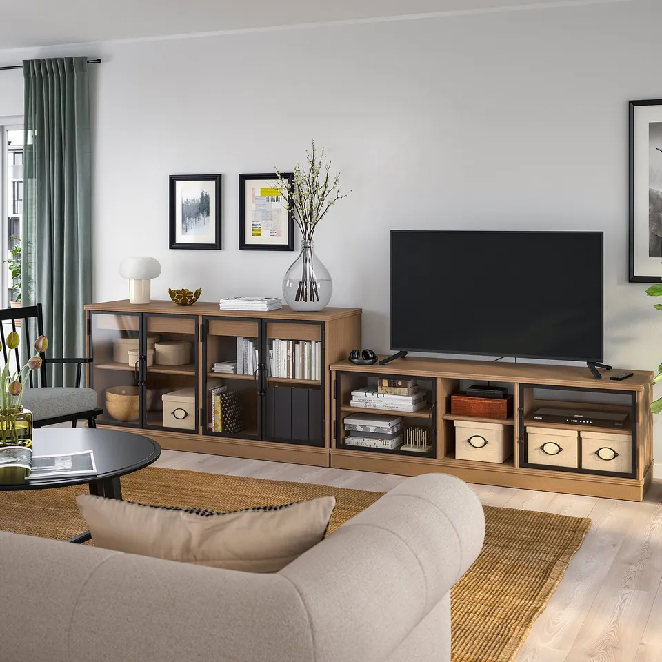 Modern living room with wooden tv stand and sideboard, featuring decor and cosy seating.