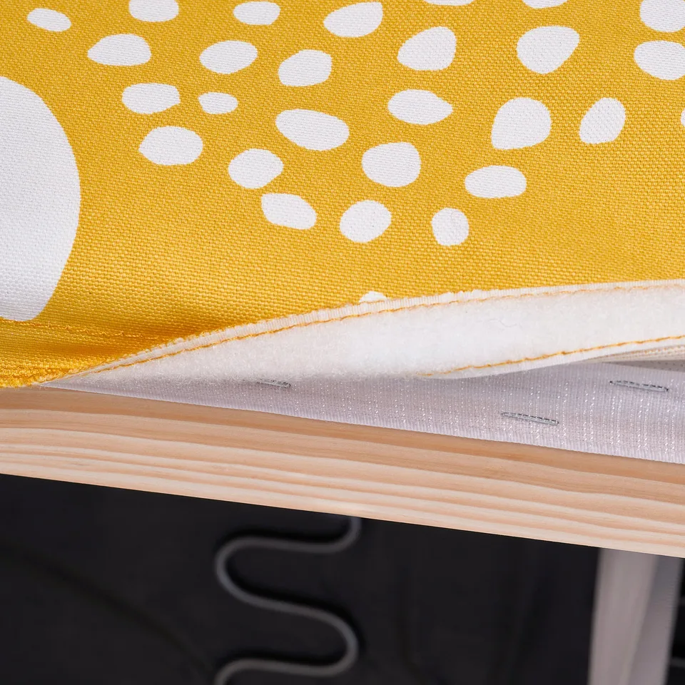 Close-up of yellow dotted cushion with foam on sofa, showcasing comfort and durability.