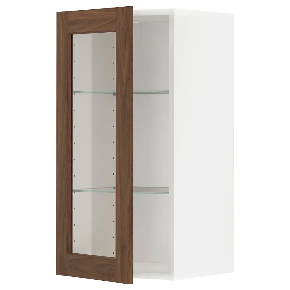 METOD kitchen cabinet with open walnut-brown door, glass shelves, white frame.