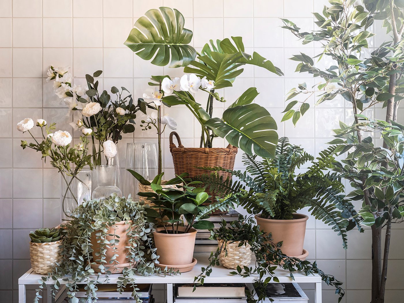 FEJKA artificial plants & flowers on table: ferns, monstera, white roses.