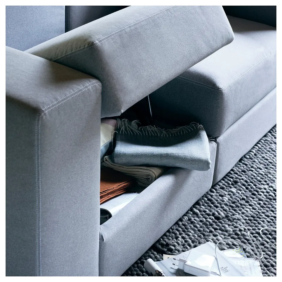 Modern light grey modular sofa with storage, featuring soft cushions and a stylish, minimalist design.