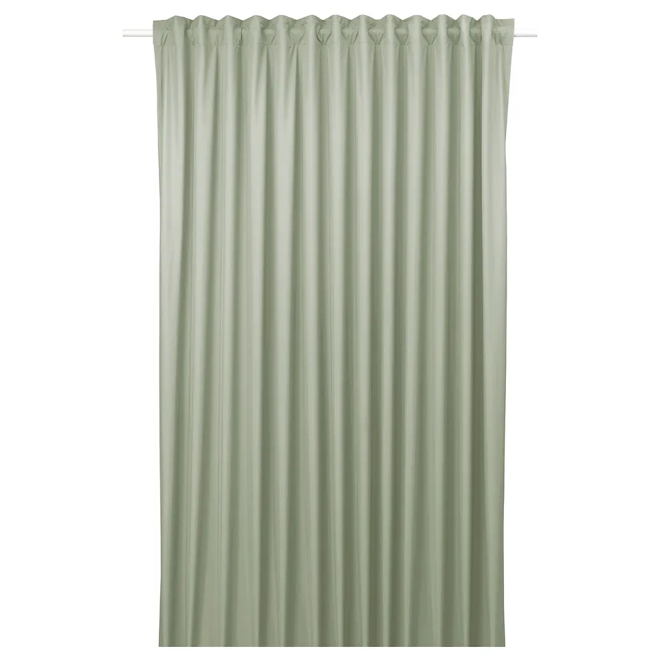 BENGTA green blockout curtain with peach skin texture. Simple, rectangular design, hangs neatly with heading tape.