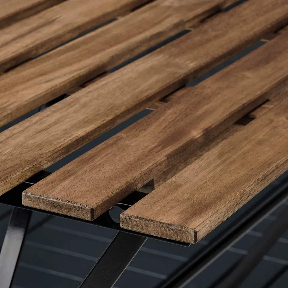 Wooden outdoor furniture detail. Durable acacia hardwood slats supported by black powder-coated steel frame.