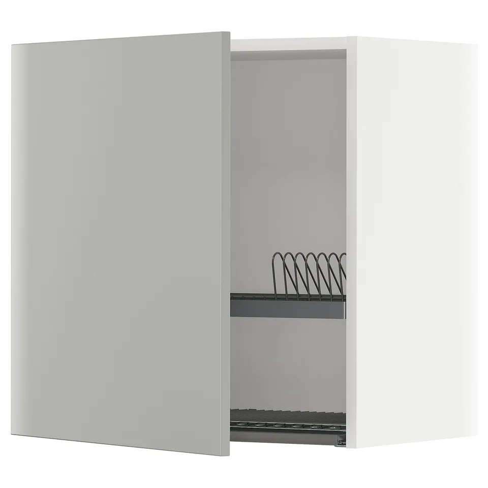 White modular METOD kitchen cabinet with grey interior and wire dish drainer.