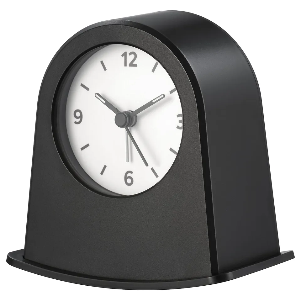 A black KÄRRSÅNGARE clock with a round face and minimalist design.