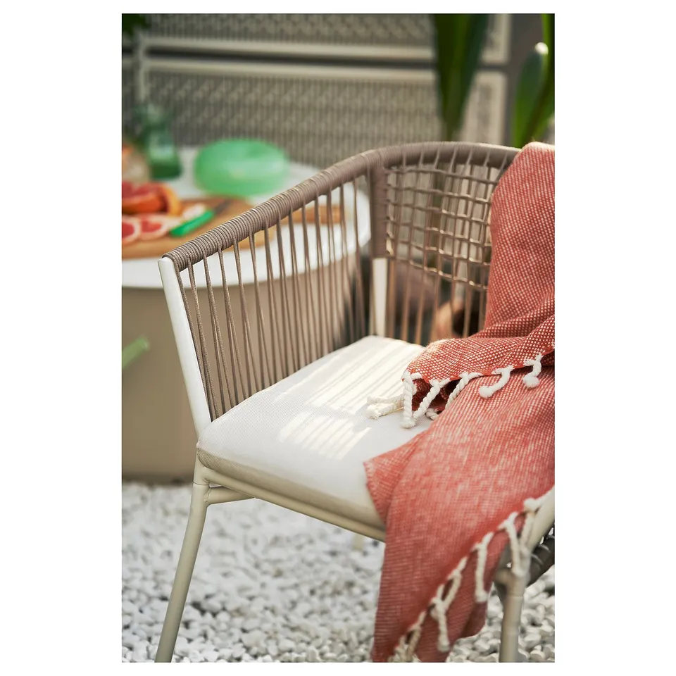 SEGERÖN chair: woven rope, white cushion, outdoor, steel frame, minimalist.