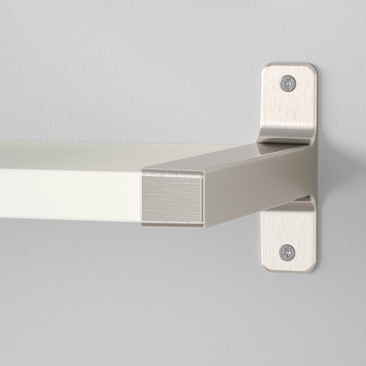 Close-up of modern metal wall shelf bracket with clean, satin finish and hidden screws. Shows quality craftsmanship.