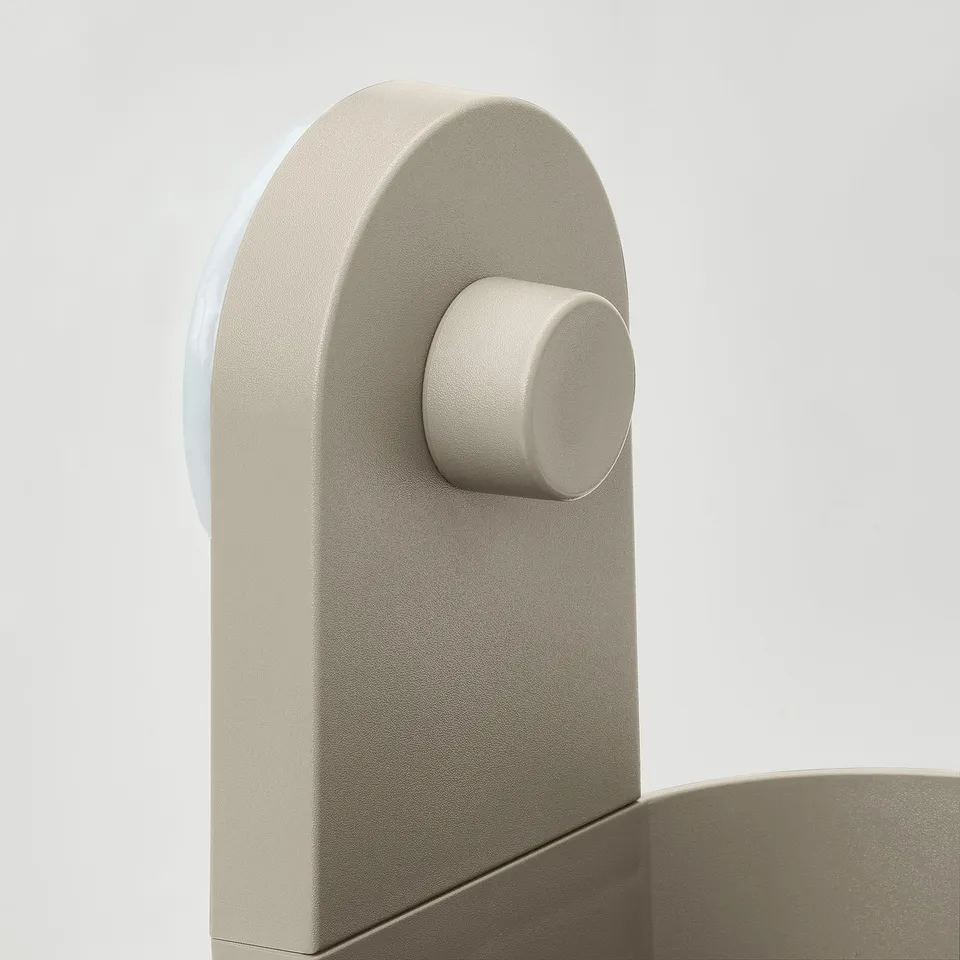 Modern wall organiser in neutral tone, smooth rounded edges, showing suction cup and connector detail.