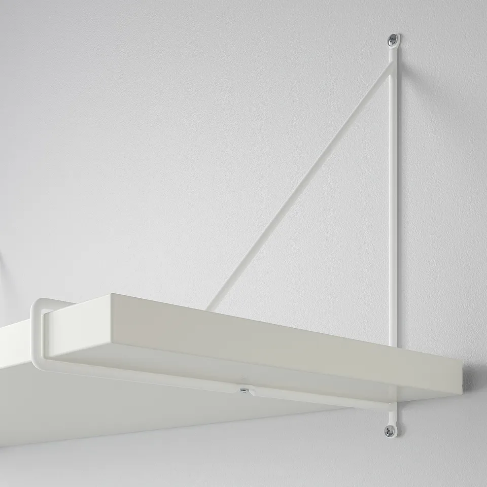 Wall-mounted white shelf with diagonal support bracket, securely attached to off-white wall, showing modern design and sturdy structure.
