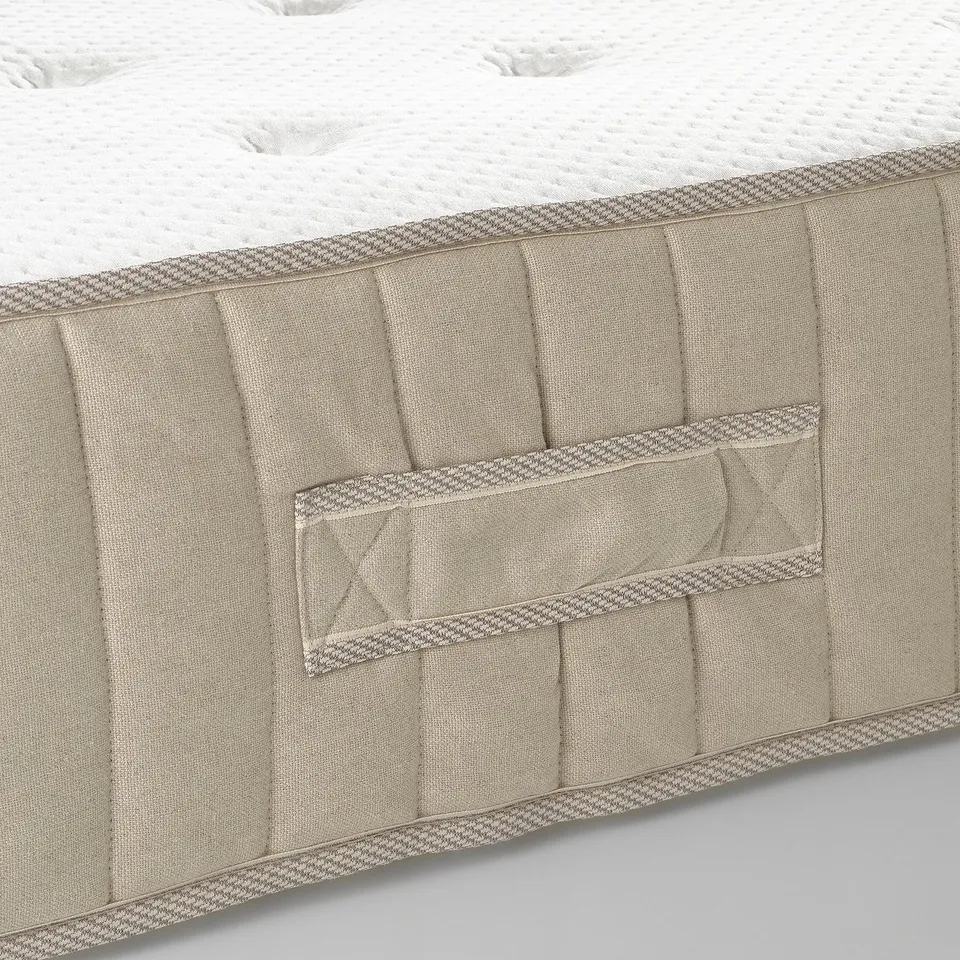 Close-up of high-quality mattress showcasing detailed craftsmanship, natural materials, and supportive pocket springs.