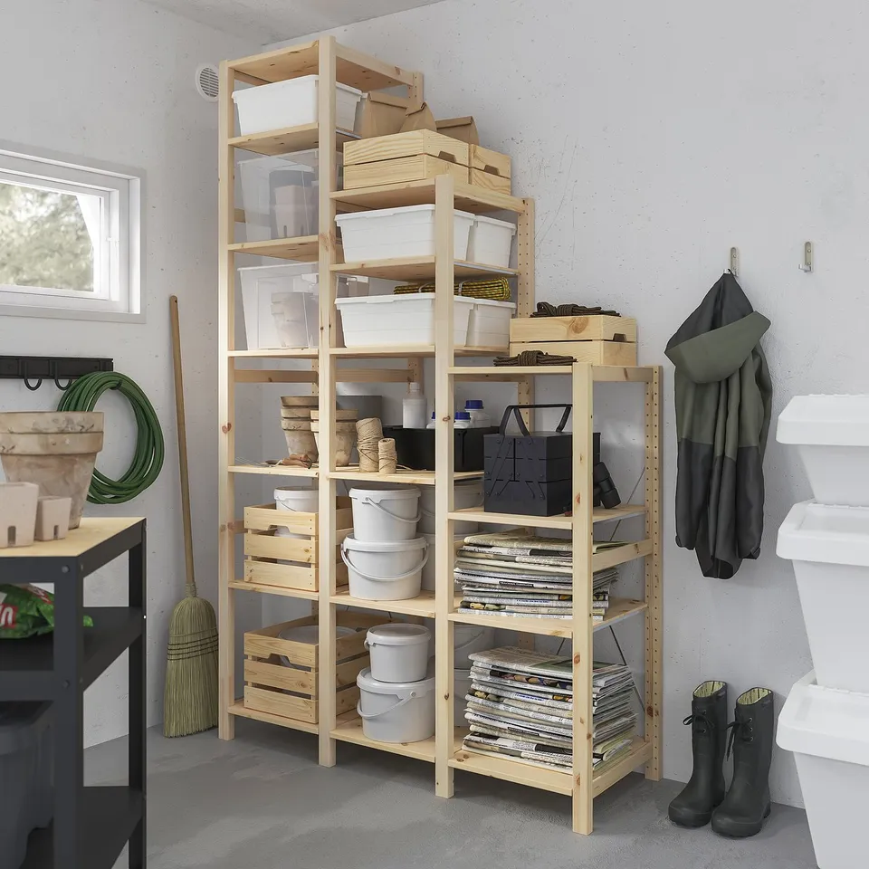 Wood IVAR shelf holds grey buckes, white boxes, tools. Tall, fits wall. "