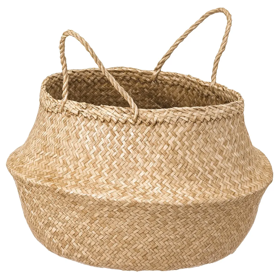 A round woven seagrass basket named FLÅDIS. It has twisted rope handles for easy carrying.