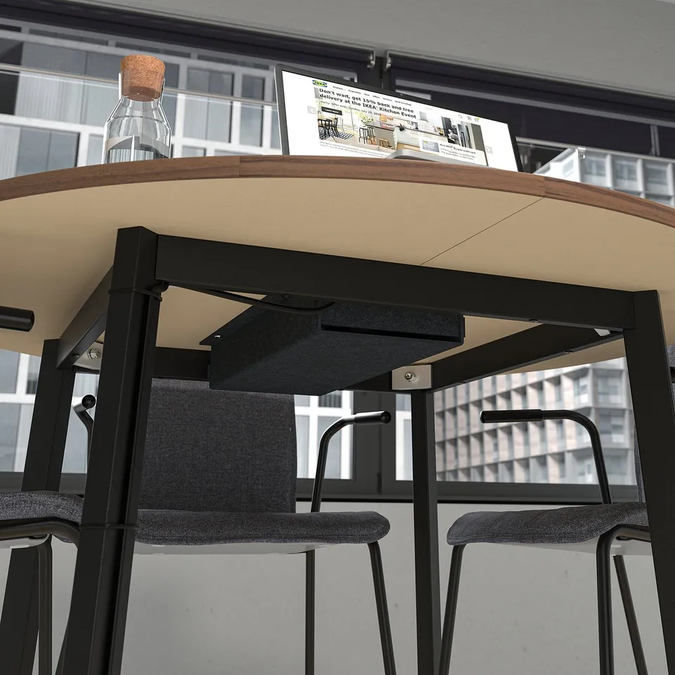 Round conference table with chairs. Designed for small group discussions and easy cable management.