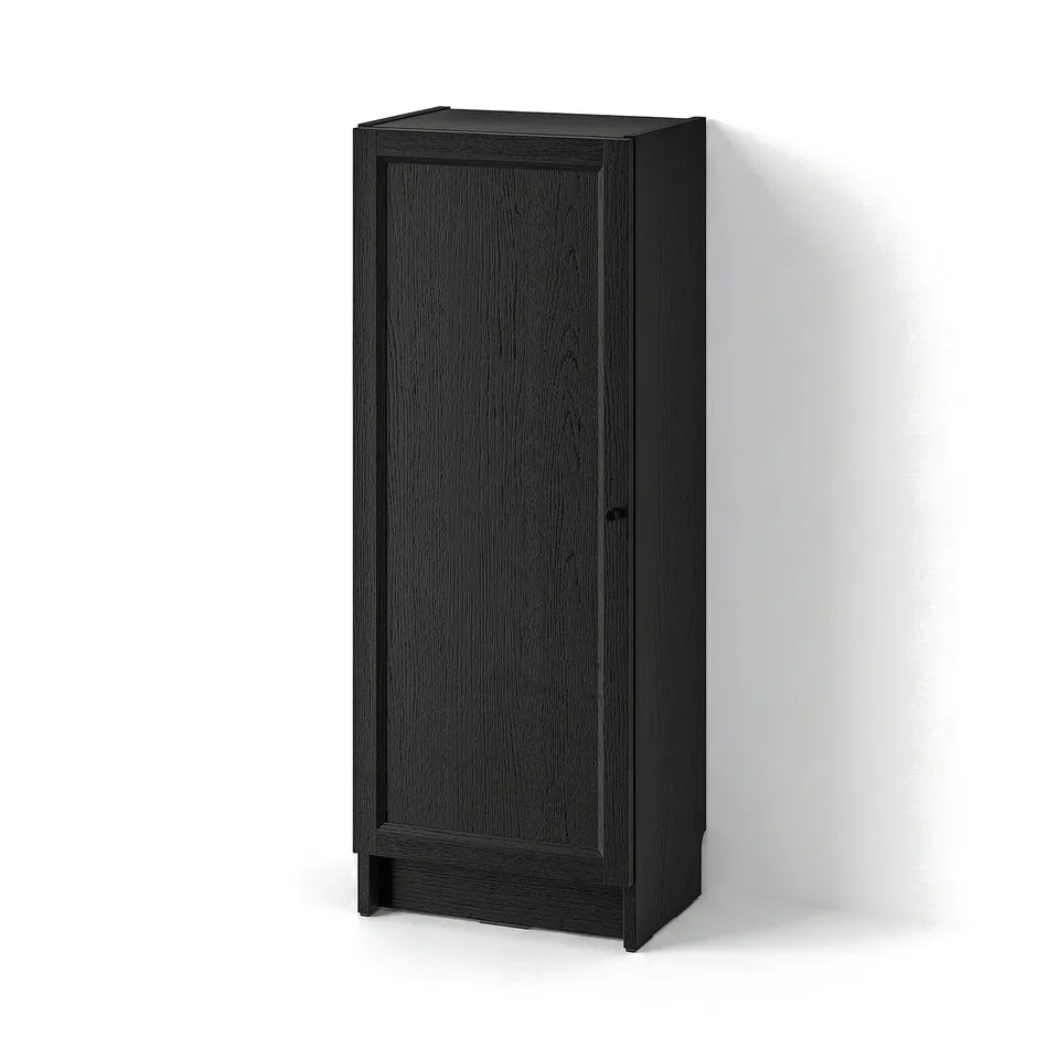 Black BILLY bookcase, tall and rectangular with single panel door, wooden texture, minimalist design.