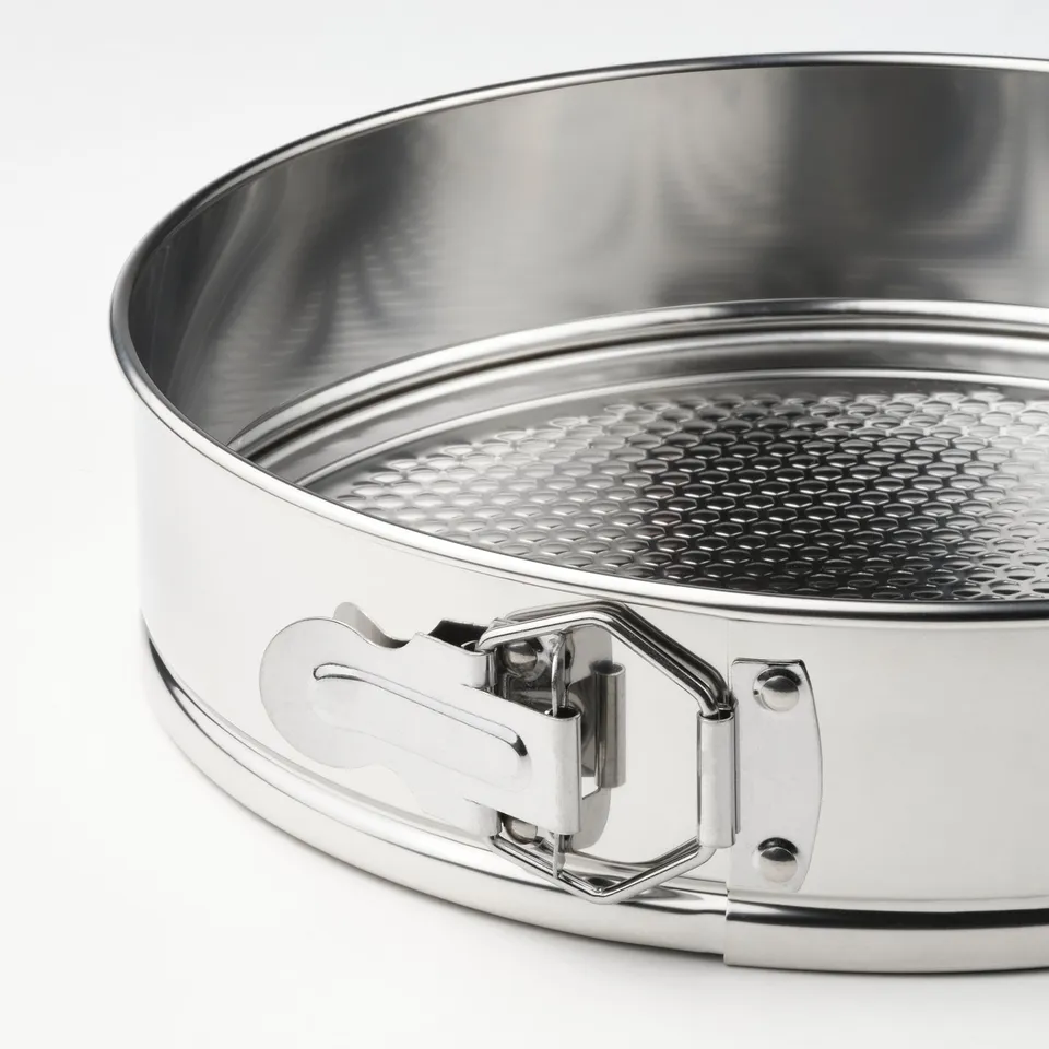 Stainless steel springform pan with textured base, secure clasp and easy side release, ideal for baking.