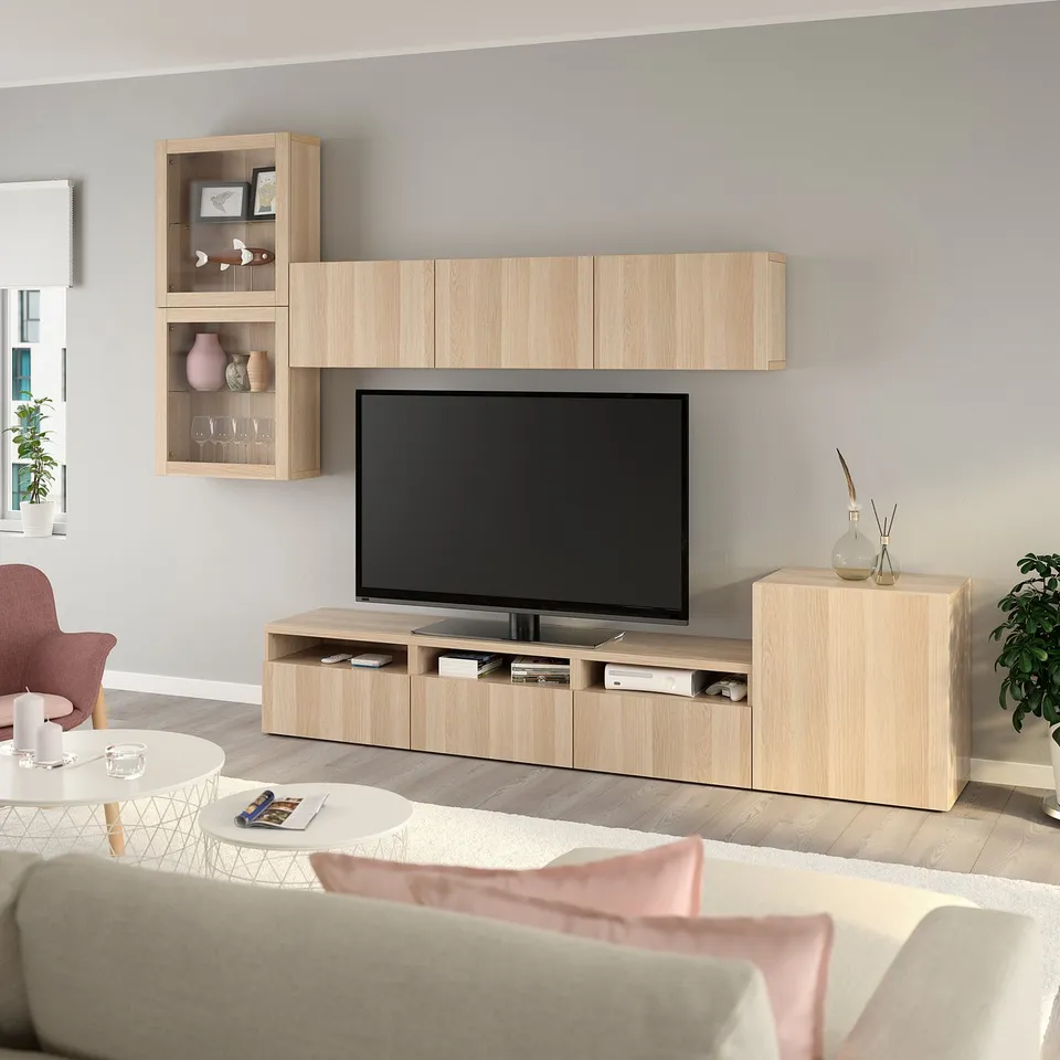 Modern living room with large wooden tv unit. Flat screen tv, decor, and comfortable furniture.
