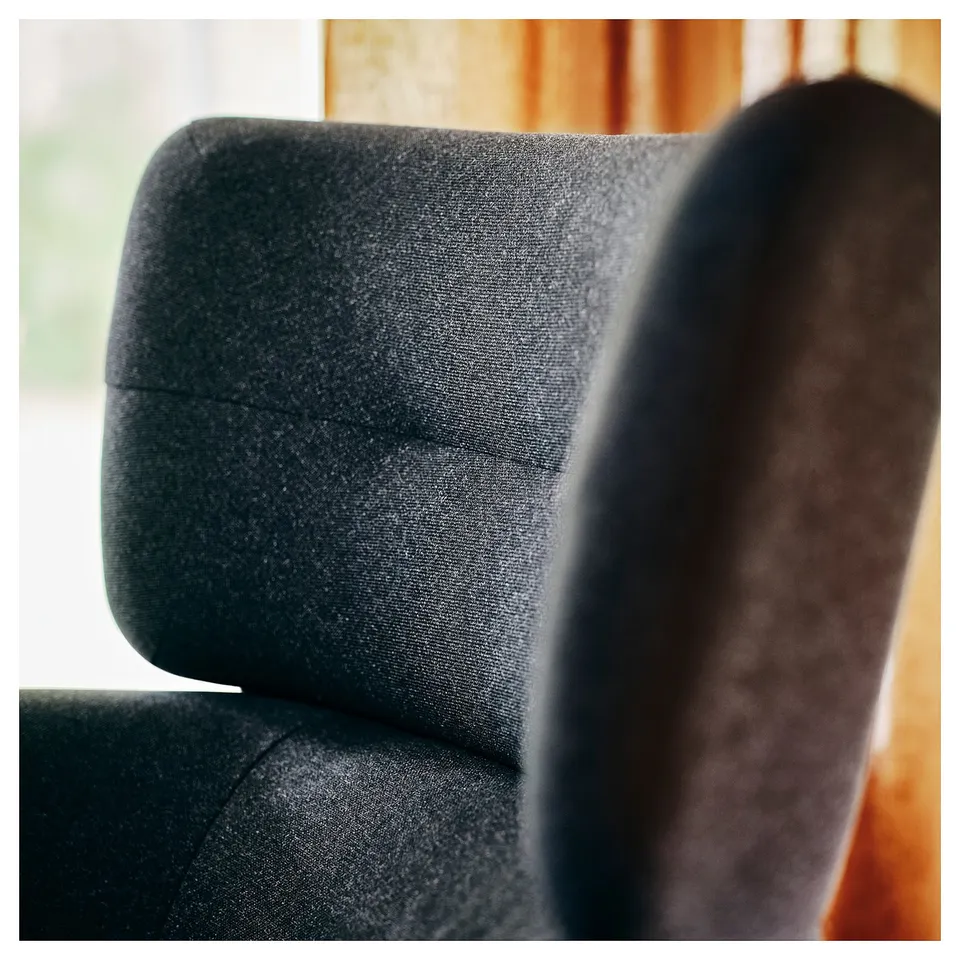 Close-up of a plush, dark grey, ergonomic office chair, showcasing high-quality fabric and supportive design.