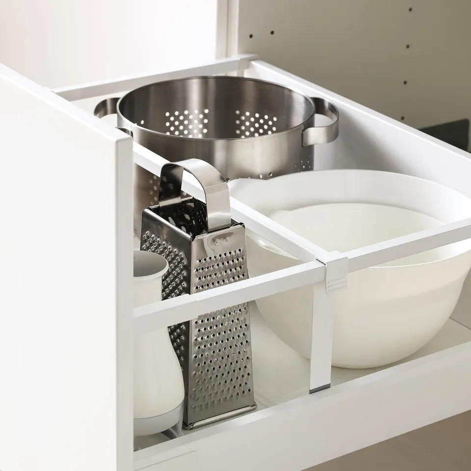 Open kitchen drawer with utensils.