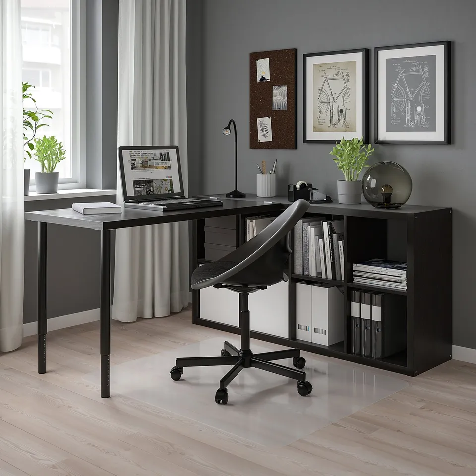 Modern office: l-shaped desk, bookshelves, chair, laptop, books, plants.
