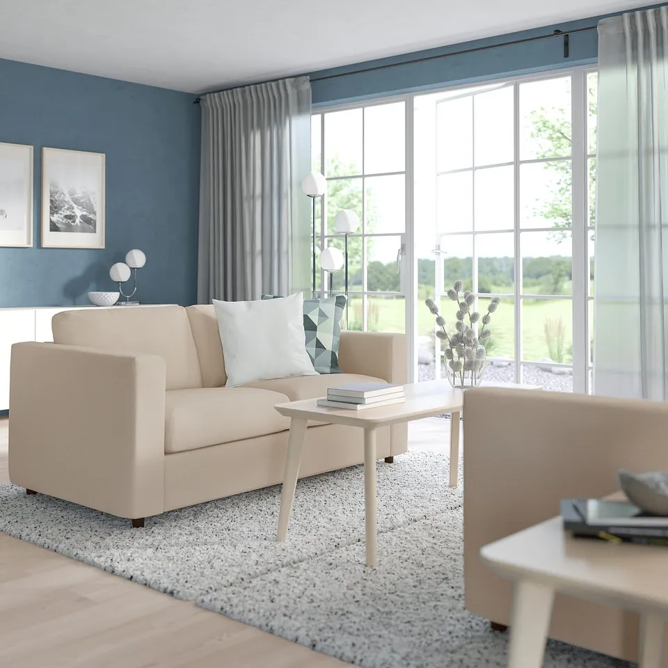 Cosy living room with VIMLE sofa, coffee table, blue walls, plant.