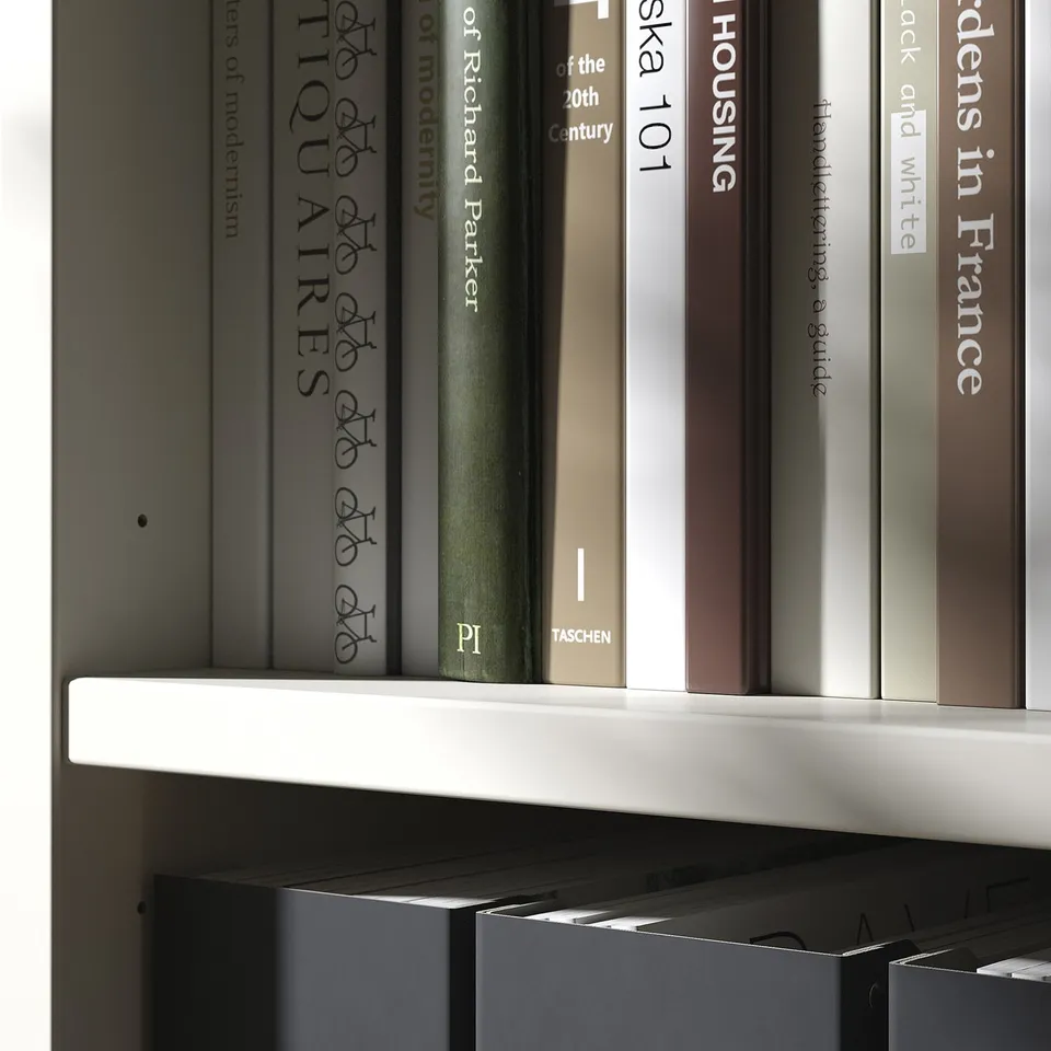 Books neatly arranged on shelves. Modern design, off-white colour. Wooden and sturdy material.