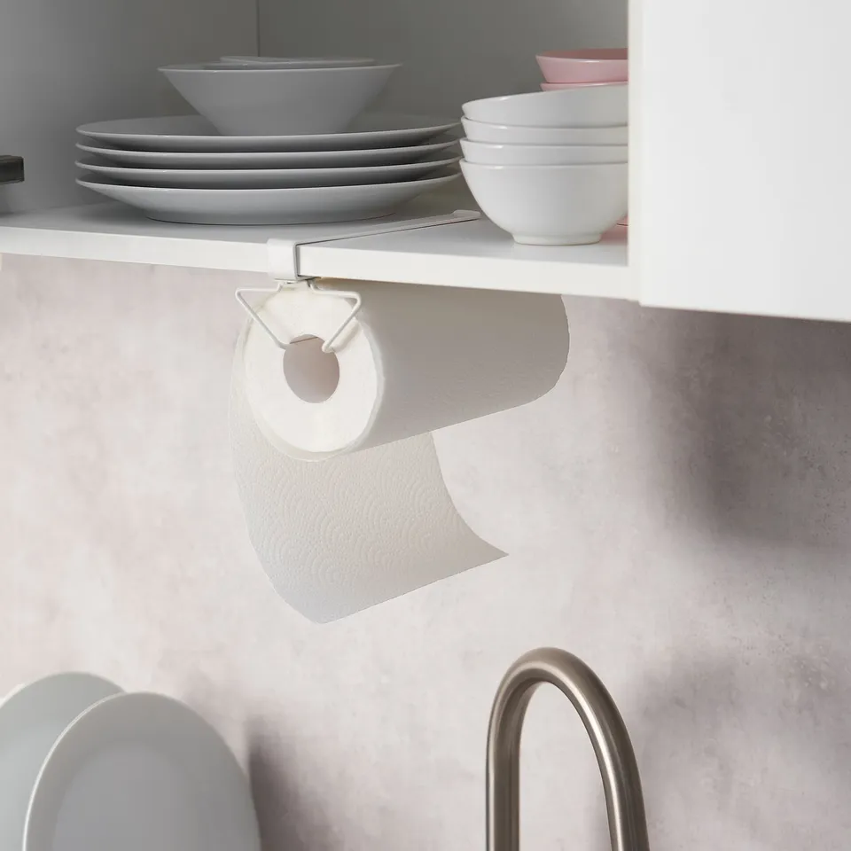 Kitchen shelf with plates, bowls, and paper towels on PÅLYCKE rack.