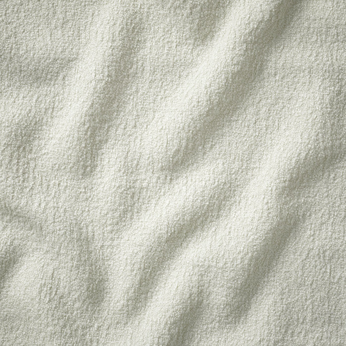 Close-up texture of UPPÅKRA couch: soft, woven bouclé fabric, showing detailed stitching.