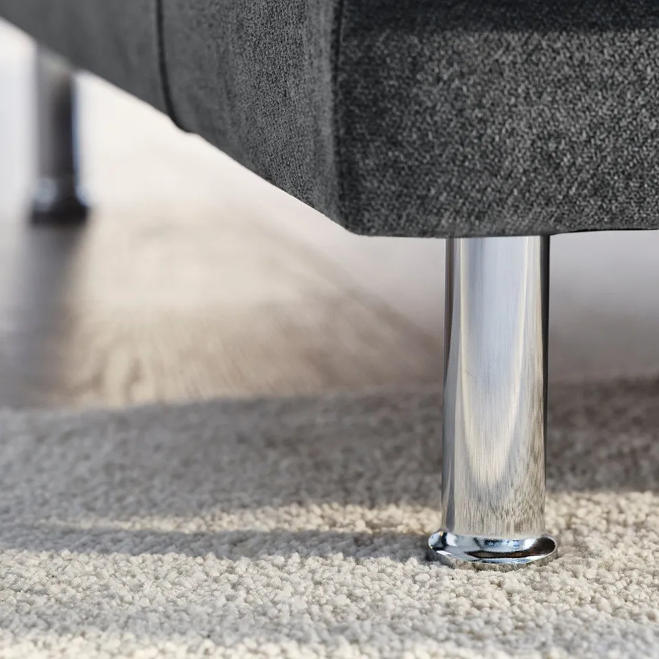 Close-up of UPPÅKRA sofa leg, polished chrome, sturdy build, sleek design.